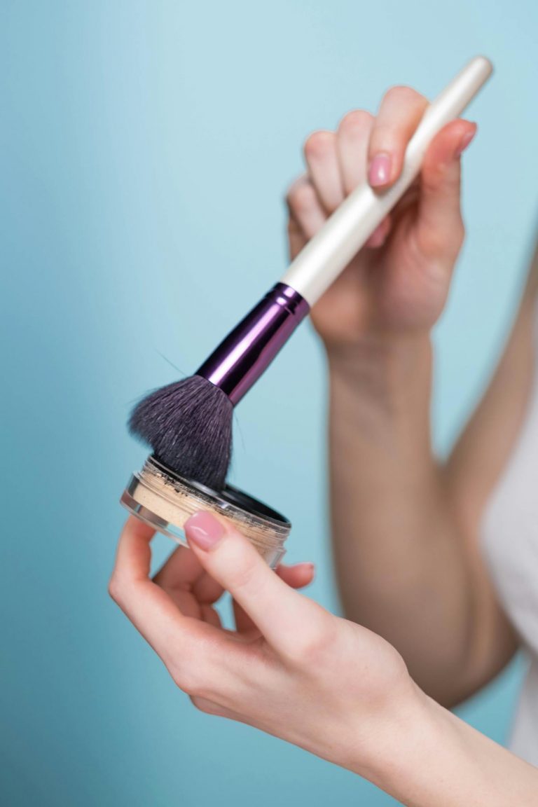 A woman applying facial powder with a brush, highlighting a makeup routine.